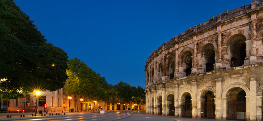 Fototapeta na wymiar View of famous amphitheater by night, Nimes,