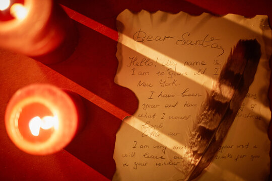 Background image of parchment letter to Santa with quill and candles setup, copy space