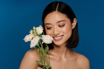 Portrait of young beautiful smiling asian woman with white flowers
