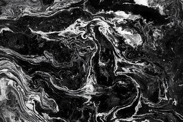 Acrylic paint abstract background. Mixture of white, black and golden paints making mysteries...