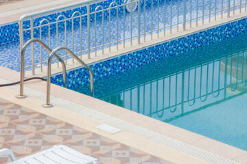 Obraz premium Pool filling with water before purification. Handrails for entering the pool