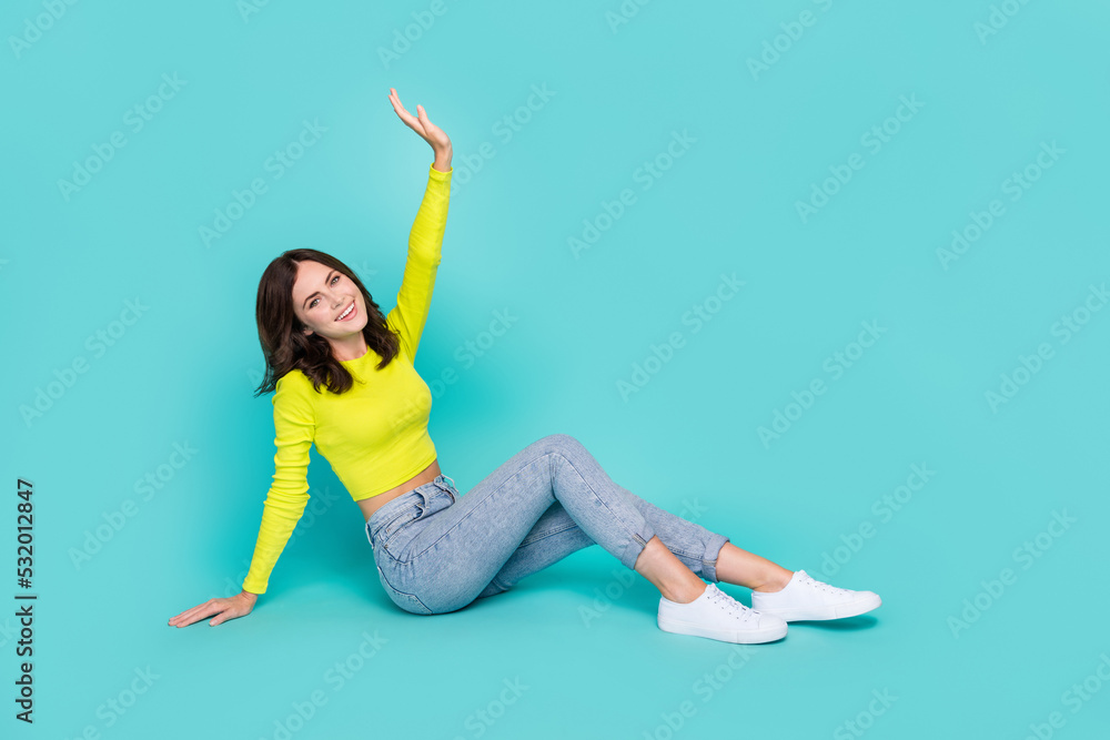 Canvas Prints full size profile portrait of cheerful nice girl sit floor raise arm isolated on turquoise color bac