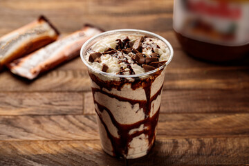 Nutella milkshake served in glass side view on wooden table morning meal