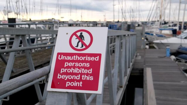 Unauthorised persons prohibited beyond this point sign in a marina 