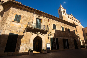 Manacor, Palma de Mallorca - Spain - September 15, 2022. In front of the town hall of Manacor with flags of the Balearic Islands, Spain and Mallorca flaming by the wind