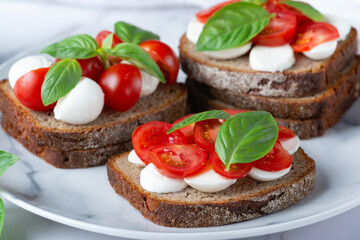 Bruschetta with mozzarella, tomatoes and basil. Vegetarian food. Healthy eating