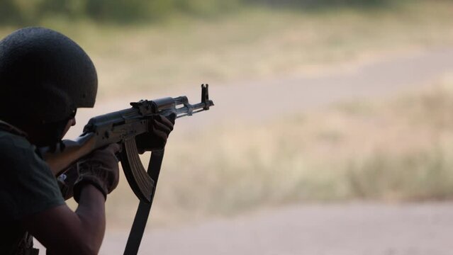 Defending the nation in a green uniform vest with a machine gun in hand, soldier holding a gun, military, army war concept, ready to attack, military machine gun crew shooting, army gunner attacking