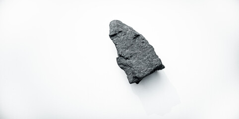 A piece of black coal on a white isolate. Coal for kindling industrial furnaces on a white background.