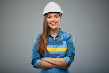 Woman architect or engineer in safety industrial helmet standing with arms crossed. Isolated female...