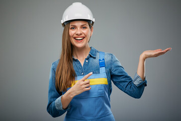 Woman engineer in safety industrial helmet holding empty hand. Isolated female portrait.