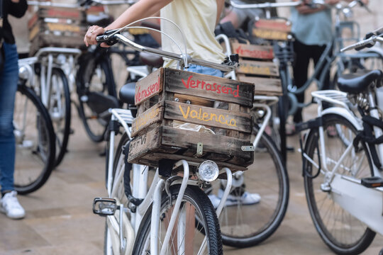 group of tourists cycling on bicycle tour around the Valencia city, Spain. Bicycles with wooden baskets available for rent for city tours. Mobile movement around the city by Bicycle. eco tourism.