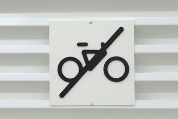No Cycling prohibition black icon sign on metal fence. No Bicycles.