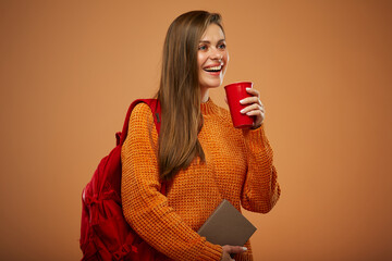 Student woman with book holding red coffee cup and looking away. Isolated female portrait.