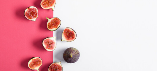 Pattern made of fresh ripe figs on pink and white background. Flat lay, top view of fresh ripe...