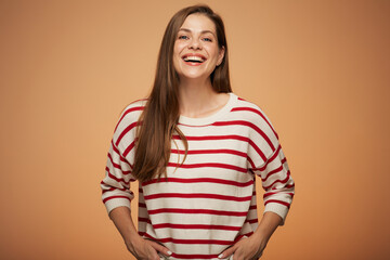 Obraz premium Smiling woman in casual clothes with hands in pockets. Isolated female portrait.