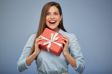 Young smiling woman holding red gift box. Isolated female portrait.