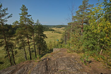 Fototapeta na wymiar View of the Karelian forests from the top of a rocky mountain.