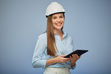 Smiling woman engineer in safety helmet holding tablet. Isolated female portrait. - 532025803