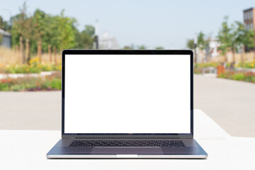 laptop mockup. Notebook with white screen morning city urban public space on background. Urban, and remote work and study concept. Empty copy space, blank screen modern laptop.