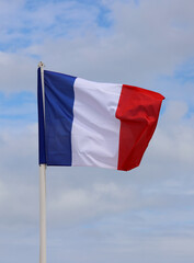French flag waving blue sky background