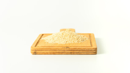 Breadcrumbs on wooden surface isolated on white background. Stack of breadcrumbs