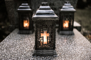 lit candles (lanterns) in the cemetery decorating graves during the Polish All Saints Day on...