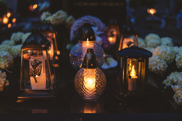 lit candles (lanterns) in the cemetery decorating graves during the Polish All Saints Day on...