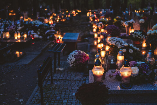 lit candles (lanterns) in the cemetery decorating graves during the Polish All Saints Day on November 1. Evening. Night. Blurred background. All Souls' Day.