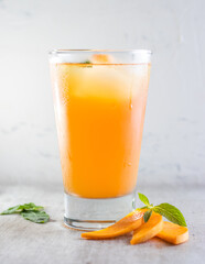 cup of tea  passion fruit and mango with lemon and a mint leaf.