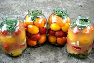 homemade canning of tomatoes in large jars, close-up as a texture for a background