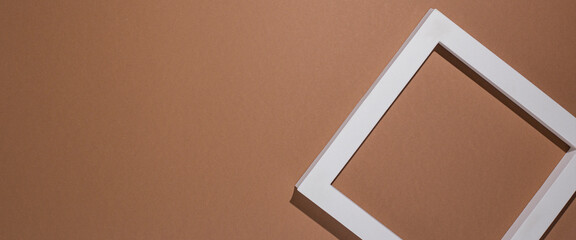 Podium for presentation square white frame on brown background. Top view, flat lay. Banner