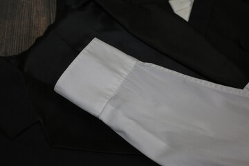 Classic tailcoat suit. White shirt, white bow tie and black jacket. Suit for ballroom dancing. Wedding accessories