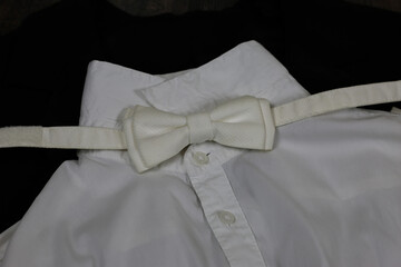 Classic tailcoat suit. White shirt, white bow tie and black jacket. Suit for ballroom dancing. Wedding accessories