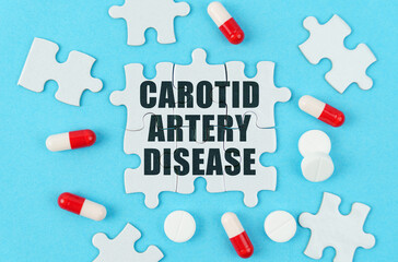 On a blue background, pills, capsules and puzzles with the inscription - Carotid artery disease