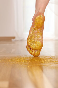 Golden glitters on female bare feet. Follow your dreams , leave your Mark on the world concept.