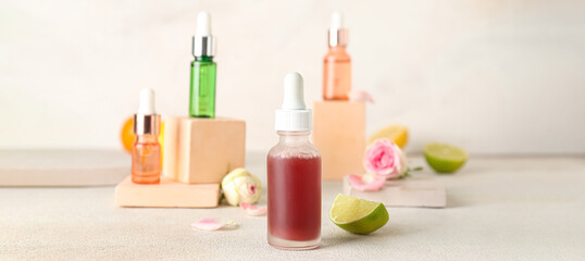 Obraz na płótnie Canvas Bottles of citrus essential oil on light table