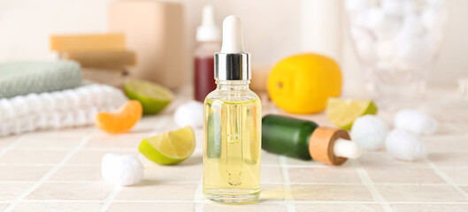 Bottle of citrus essential oil on table