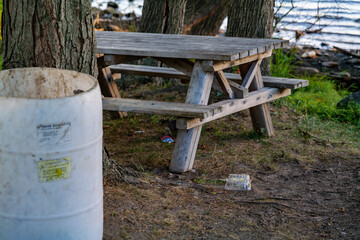 White plastic barrel for garbage in a park near Rockland Lake, New York. High-quality photo