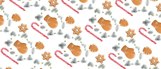 Many gingerbread cookies, candy canes and Christmas tree branches on white background. Pattern for design