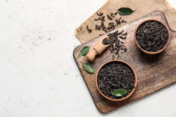 Composition with dry tea leaves on white background