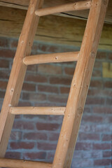 new wooden stairs inside the house, red brick wall in the background, beautiful detail in the interior of the house