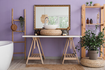 Fototapeta na wymiar Modern sink, houseplant and shelf unit with bath accessories near color wall