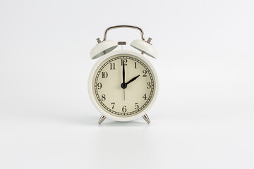 White retro clock alarm clock on white background shows 02:00 am or 02:00 pm or 14:00