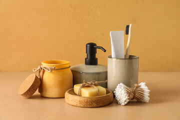 Set of bath supplies with cotton swabs on color background