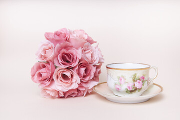 Romantic rose flowers with antique tea cup and saucer