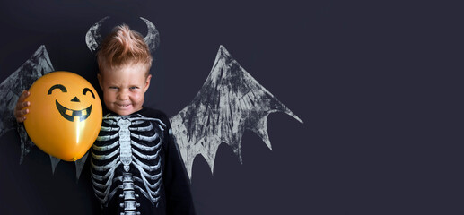 Happy halloween card with dressed boy over dark background