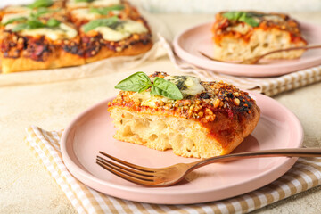 Plate of tasty Italian pie with mozzarella and pesto sauce on light background, closeup