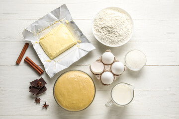 Set of ingredients for baking on light wooden background