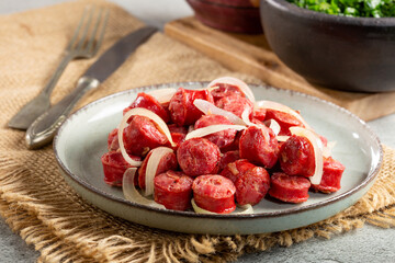 Portion of sausage with onion.