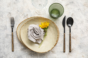 Stylish table setting with beautiful sunflower on light background